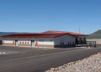 Finished building and wash bay building of Whiteriver District Transportation Center on a sunny day